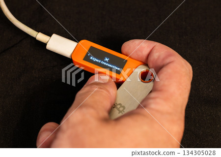 Caucasian man rejecting transaction indoors with hardware wallet Caucasian man rejecting transaction indoors with hardware wallet 134305028