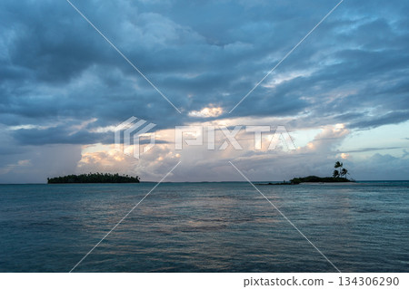 Sunset over two tropical motu on Tikehau Atoll, French Polynesia Sunset over two tropical motu on Tikehau Atoll, French Polynesia 134306290