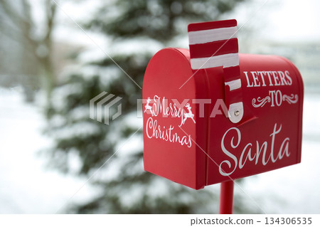 Santa's Mailbox in Snowy Scene. Red mailbox for letters to Santa, set in a snowy winter background 134306535