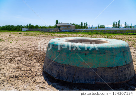 Green kazan in Kok-Boru stadium at sunny summer day. 134307154