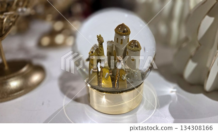 Festive christmas and new year decorative snow globe for holiday celebration. Epiphany celebrations. Three Kings Day. Wise Men bring gifts 134308166