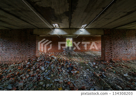 Abandoned interior of a desolate building with rubble and debris Abandoned interior of a desolate building with rubble and debris 134308203