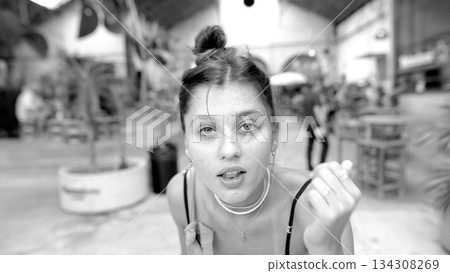 A Young Woman Dressed in Black and White Photographed in a Dynamic Urban Environment A Young Woman Dressed in Black and White Photographed in a Dynamic Urban Environment 134308269