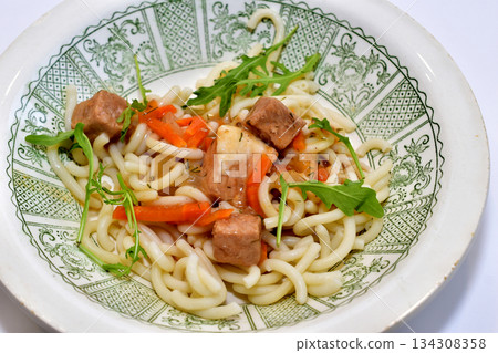 Pasta with meat on a plate. Top view. 134308358
