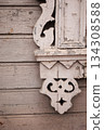 Carved wooden ornament on weathered house wall 134308588