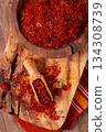 Spice saffron threads, in a wooden bowl, on a wooden table, top view, close-up, 134308739