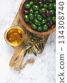 Chalkidiki olives, classic Greek green olives, in a bowl on a cutting board, top view, without people, 134308740