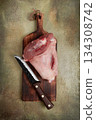 Raw pork knuckle, on a wooden chopping board, close-up, top view, no people, 134308742