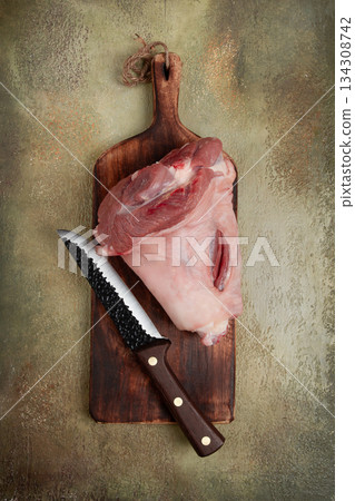 Raw pork knuckle, on a wooden chopping board, close-up, top view, no people, 134308742