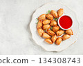 Fried mini chebureks, with sauce, on a decorative plate, hard light, no people, 134308743