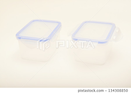 Small containers for food. Two plastic containers with a blue lid for food on a white background. Small containers for food. Two plastic containers with a blue lid for food on a white background. 134308850
