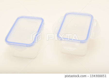 Small containers for food. Two plastic containers with a blue lid for food on a white background. Small containers for food. Two plastic containers with a blue lid for food on a white background. 134308851