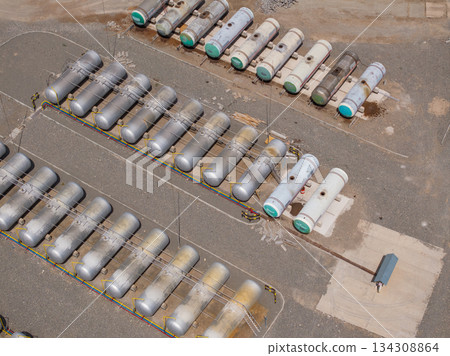 Numerous storage tanks in industrial area during daytime Numerous storage tanks in industrial area during daytime 134308864