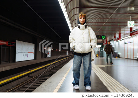 young woman in white winter jacket in the underground metro 134309243