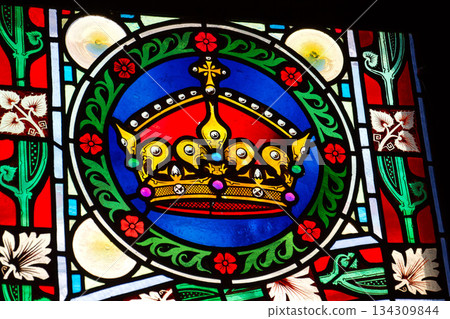 Beautifully illuminated stained glass with historic Czech motifs, colorful light, Gothic atmosphere and architectural heritage in Prague, Czech republic 134309844