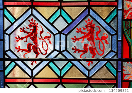 Beautifully illuminated stained glass with historic Czech motifs, colorful light, Gothic atmosphere and architectural heritage in Prague, Czech republic 134309851