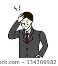 A man in a suit holding his head (color) 134309982