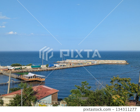 fishing pier juts out into the sea, a view of the sea on a clear day fishing pier juts out into the sea, a view of the sea on a clear day 134311277