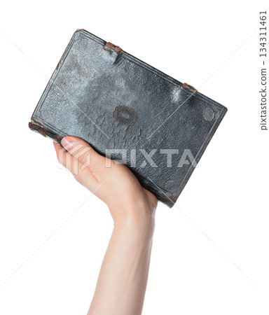 Hand holding an old antique book, isolated on transparent background. Ideal for education, history, literature, archival, and vintage-themed design projects Hand holding an old antique book, isolated on transparent background. Ideal for education, history, literature, archival, and vintage-themed design projects 134311461