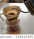 Morning time brewing coffee by hand drip. White table margin. 134312345