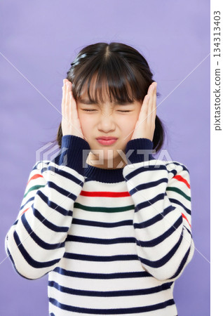 Girl annoyed by noise 134313403