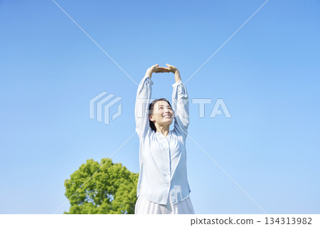 A woman stretching outdoors 134313982