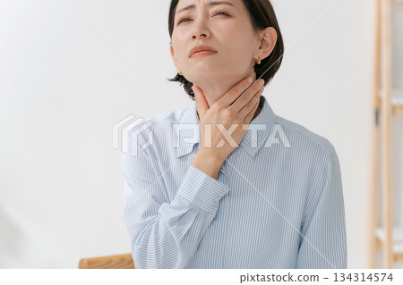 A woman complaining of neck and throat problems A woman complaining of neck and throat problems 134314574