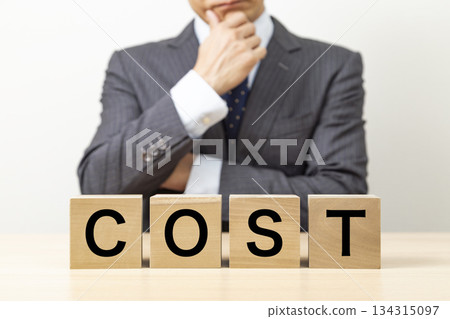 Blocks with the word "COST" written on them and businessmen Blocks with the word "COST" written on them and businessmen 134315097