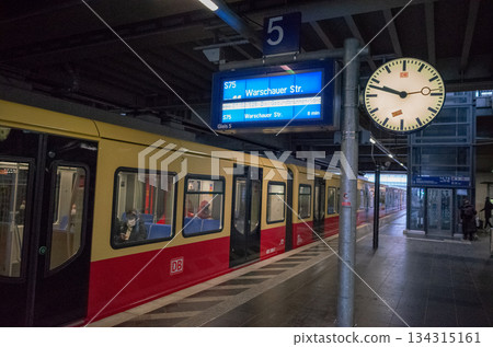 [Germany] Trains parked at a train station platform in Berlin, the capital, with a clock and destination display 134315161