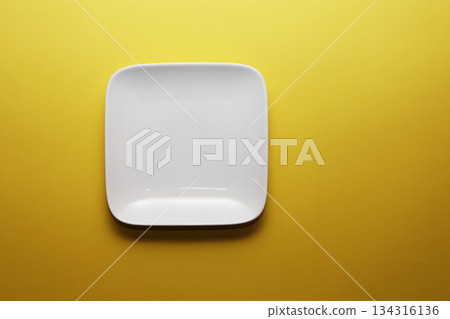 White plate on a gold background 134316136