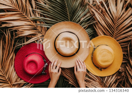 Modern Summer Fashion Setup with Stylish Hats on Palm Leaves Background 134316340