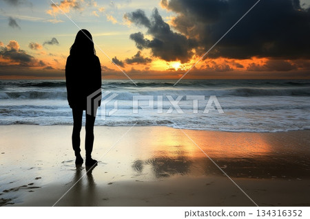 Person Standing on Beach at Sunset Experiencing Transformative Moments Along the Shoreline 134316352