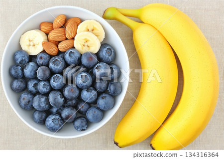 Fresh Blueberries and Bananas in Bowl on Beige Tablecloth for Healthy Eating 134316364