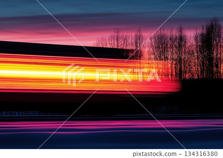 High-Speed Freight Train Moving Through Industrial Landscape at Sunset High-Speed Freight Train Moving Through Industrial Landscape at Sunset 134316380