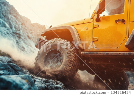 Close-Up of Rugged Off-Road Vehicle Tire Kicking Up Dust on Rocky Path Close-Up of Rugged Off-Road Vehicle Tire Kicking Up Dust on Rocky Path 134316434