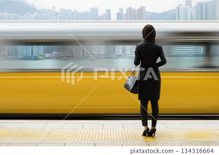 Person in Business Attire Standing Near Moving Train at Urban Station Person in Business Attire Standing Near Moving Train at Urban Station 134316664