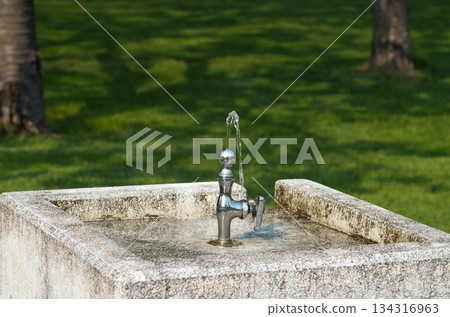Drinking tap at a park drinking fountain 134316963