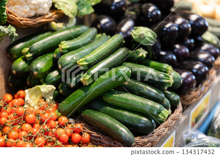 View of zucchini in a wicker basket, put up for sale in store View of zucchini in a wicker basket, put up for sale in store 134317432