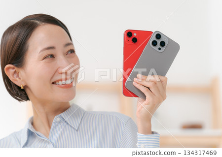 A woman with smartphone covers of various colors A woman with smartphone covers of various colors 134317469