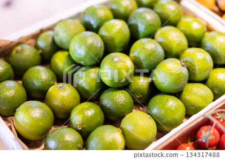 View of limes in a wicker basket, put up for sale in store View of limes in a wicker basket, put up for sale in store 134317488