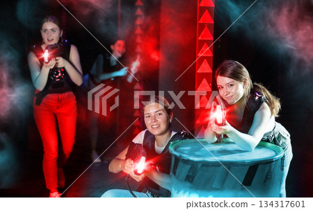 Girls play laser tag, jokingly fight with light weapons 134317601