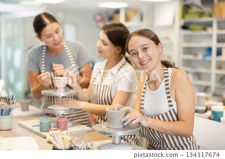 During master class, teen girl student sculpt from clay During master class, teen girl student sculpt from clay 134317674