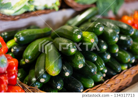 View of zucchini in a wicker basket, put up for sale in store View of zucchini in a wicker basket, put up for sale in store 134317713