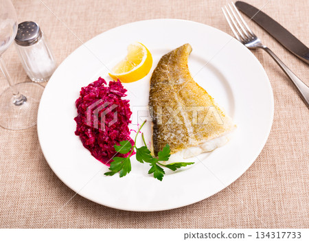 Popular dish of cuisine is Bacalao, made from appetizing cod with beet closeuo Popular dish of cuisine is Bacalao, made from appetizing cod with beet closeuo 134317733