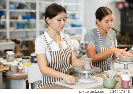 Woman teacher and student sculpt ceramic products Woman teacher and student sculpt ceramic products 134317848