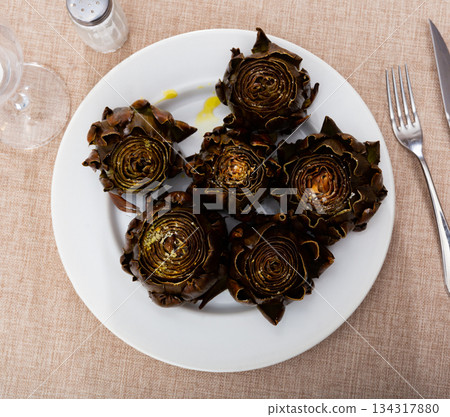 Fried or baked artichokes are dietary dish of Mediterranean cuisine Fried or baked artichokes are dietary dish of Mediterranean cuisine 134317880