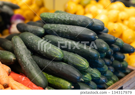 View of cucumbers in a wicker basket, put up for sale in store View of cucumbers in a wicker basket, put up for sale in store 134317979