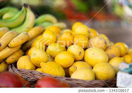 View of lemons in a wicker basket, put up for sale in store 134318017