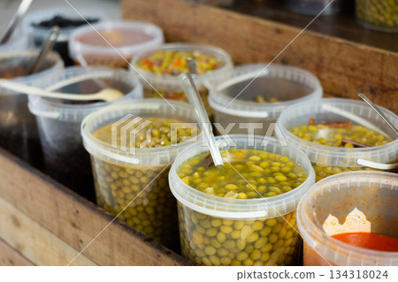 Marinated olives in plastic containers on a shelf in supermarket Marinated olives in plastic containers on a shelf in supermarket 134318024