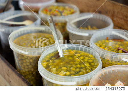 Plastic buckets are filled with pickled olives in brine Plastic buckets are filled with pickled olives in brine 134318075